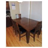 Kitchen table with one leaf self store, 4 chairs and one bench.  $200.00  Table has some wear.  