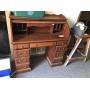 Roll top desk. Has some scratches, scuff marks.