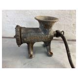 Two antique meat grinders in basket