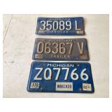 Two vintage Michigan trailer plates and one wrecker plate