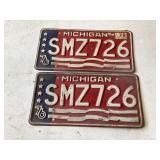Two matching 76 Michigan plates