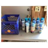 Blue spray paint cans in crate