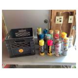 Colorful spray paint cans in crate