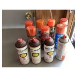 Assorted orange spray paint cans