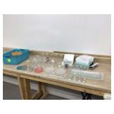 Assorted glass and lead crystal candle holders in plastic basket