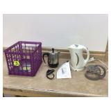 Two electric kettles and Sunbeam carafe; plastic crate